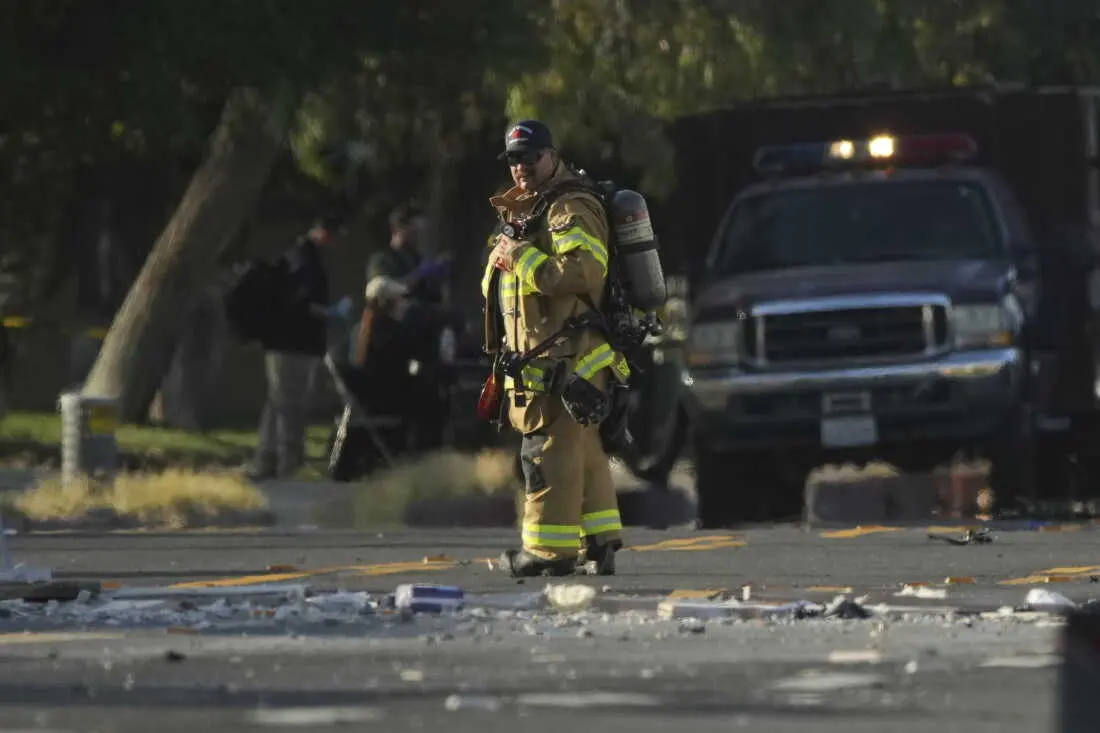 A firefighter stands at the scene of an explosion in Palm Springs, Calif., on Saturday.
