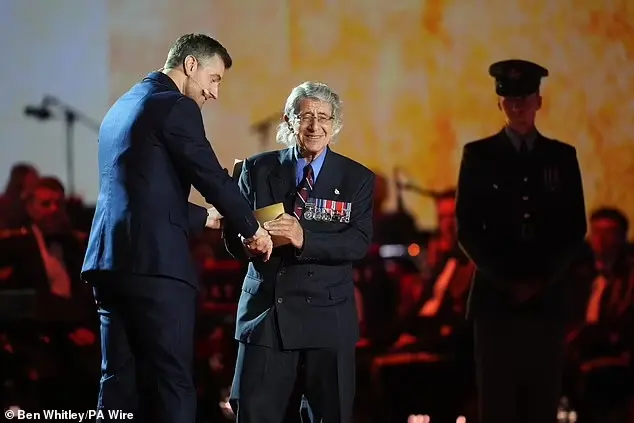Richard Armitage (left) with Blitz orphan Jeff Borsak during the concert last week, after delivering a moving speech