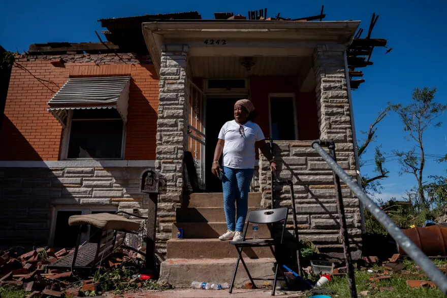 Dolly Baskin assesses damage down Penrose Street while standing in front of her north St. Louis home on Saturday, May 17, 2025. Storms and a tornado swept through a large part of the city’s center the prior day, damaging hundreds of homes and leaving at least five people dead.