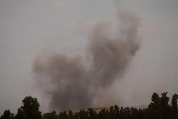 Smoke rises following an Israeli airstrike in the Gaza Strip,...
