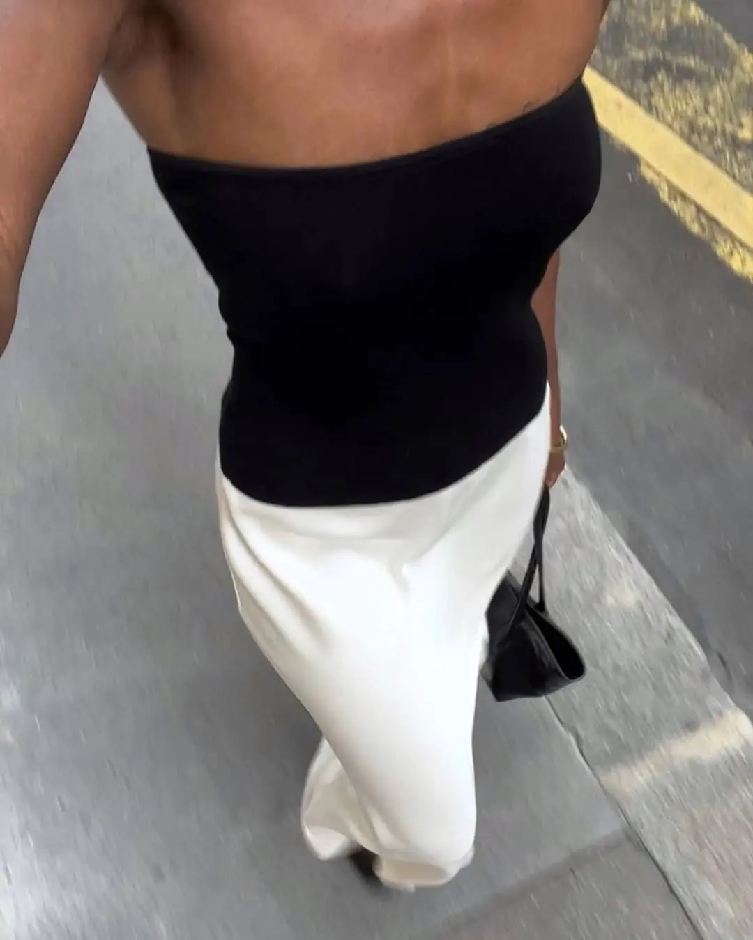 woman wearing strapless black top and white skirt