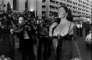 Edy Williams, appearing topless, attends the Cannes Film Festival in Cannes, France, in May 1977.