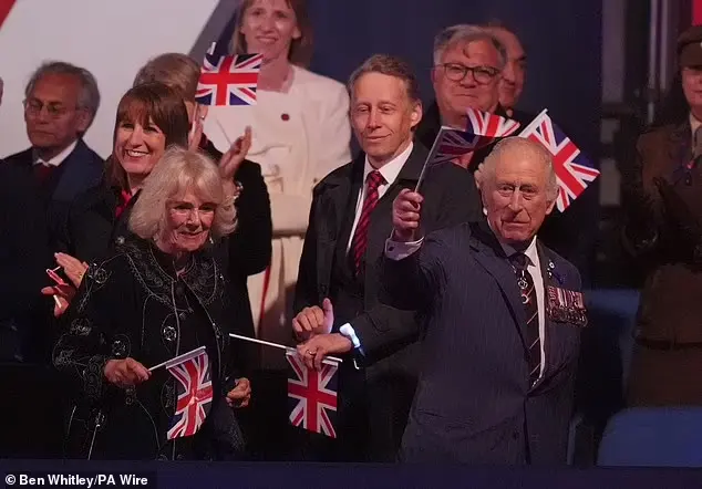 The King and Queen waving their flags as they leave the concert this evening, which took place in London
