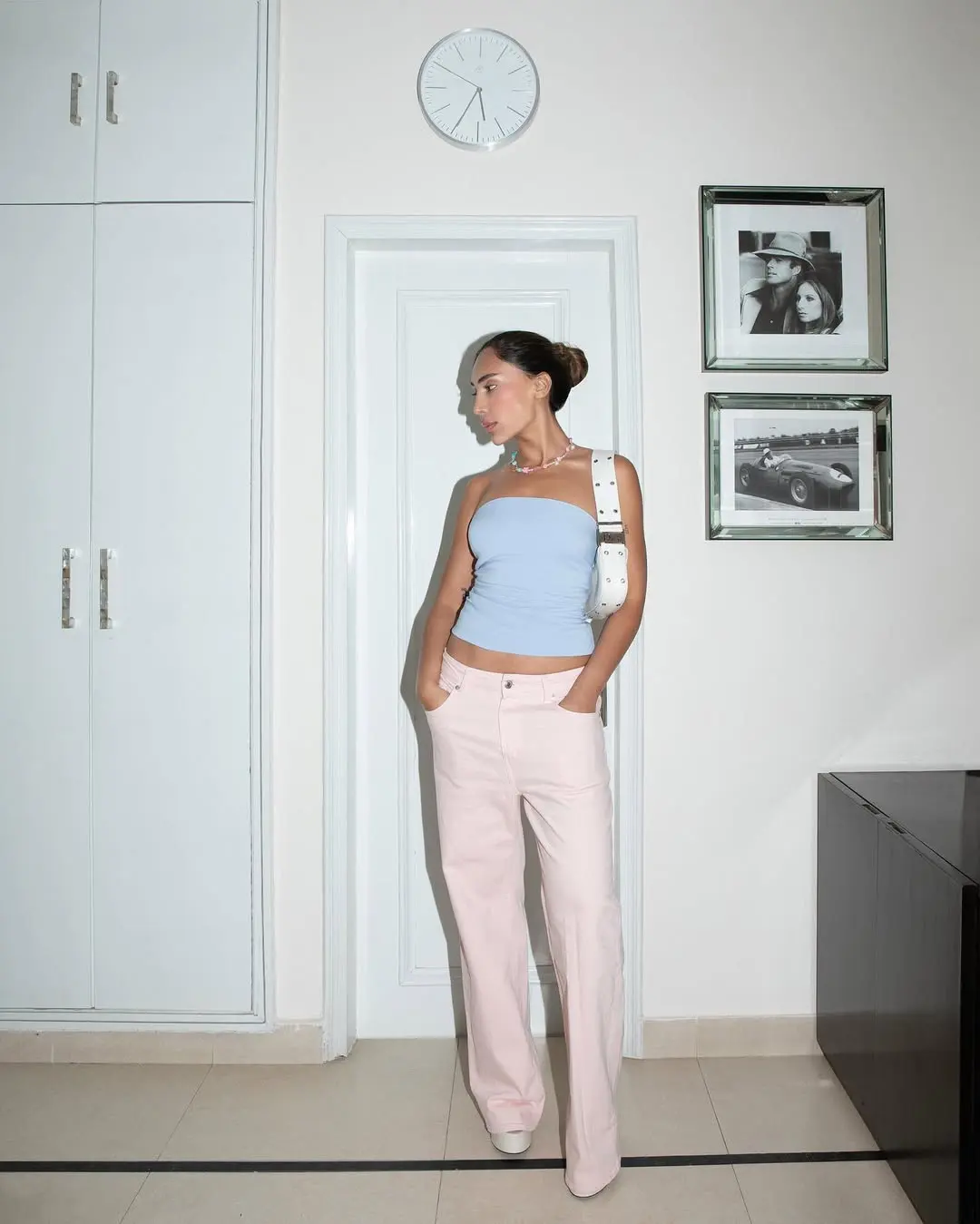 woman wearing strapless top and light pink jeans summer outfit 2025