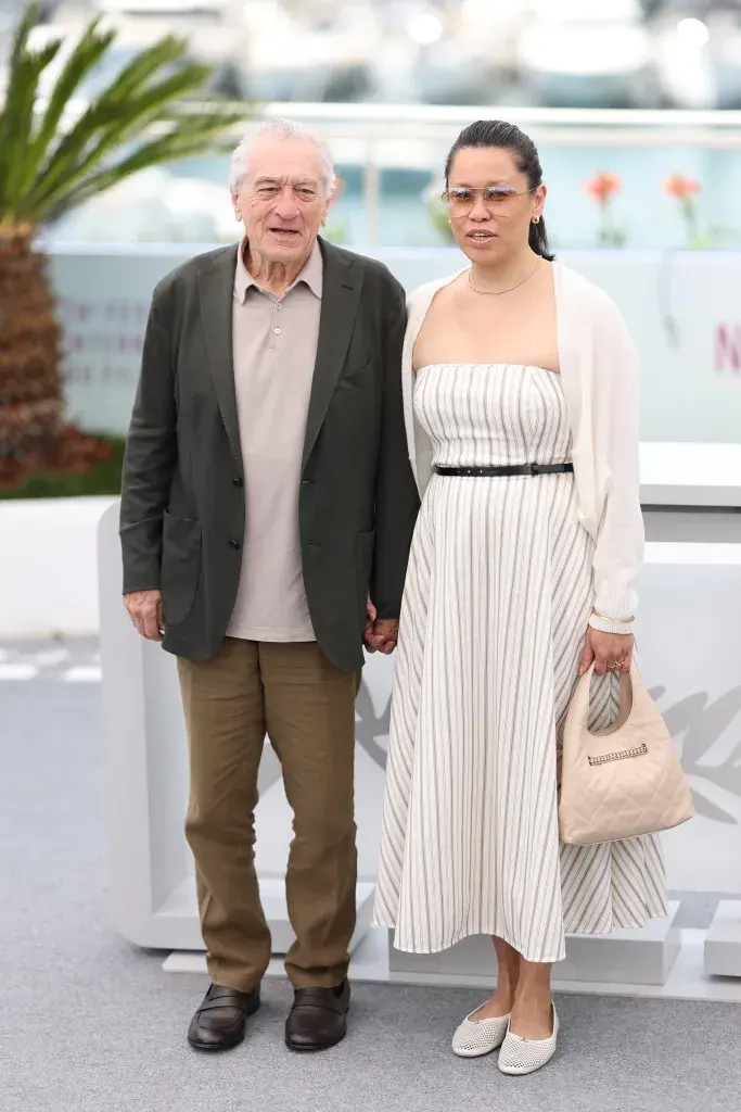 Robert De Niro and Tiffany Chen pose during the photocall for "Robert De Niro Honorary Palme D'or" at the 78th annual Cannes Film Festival.