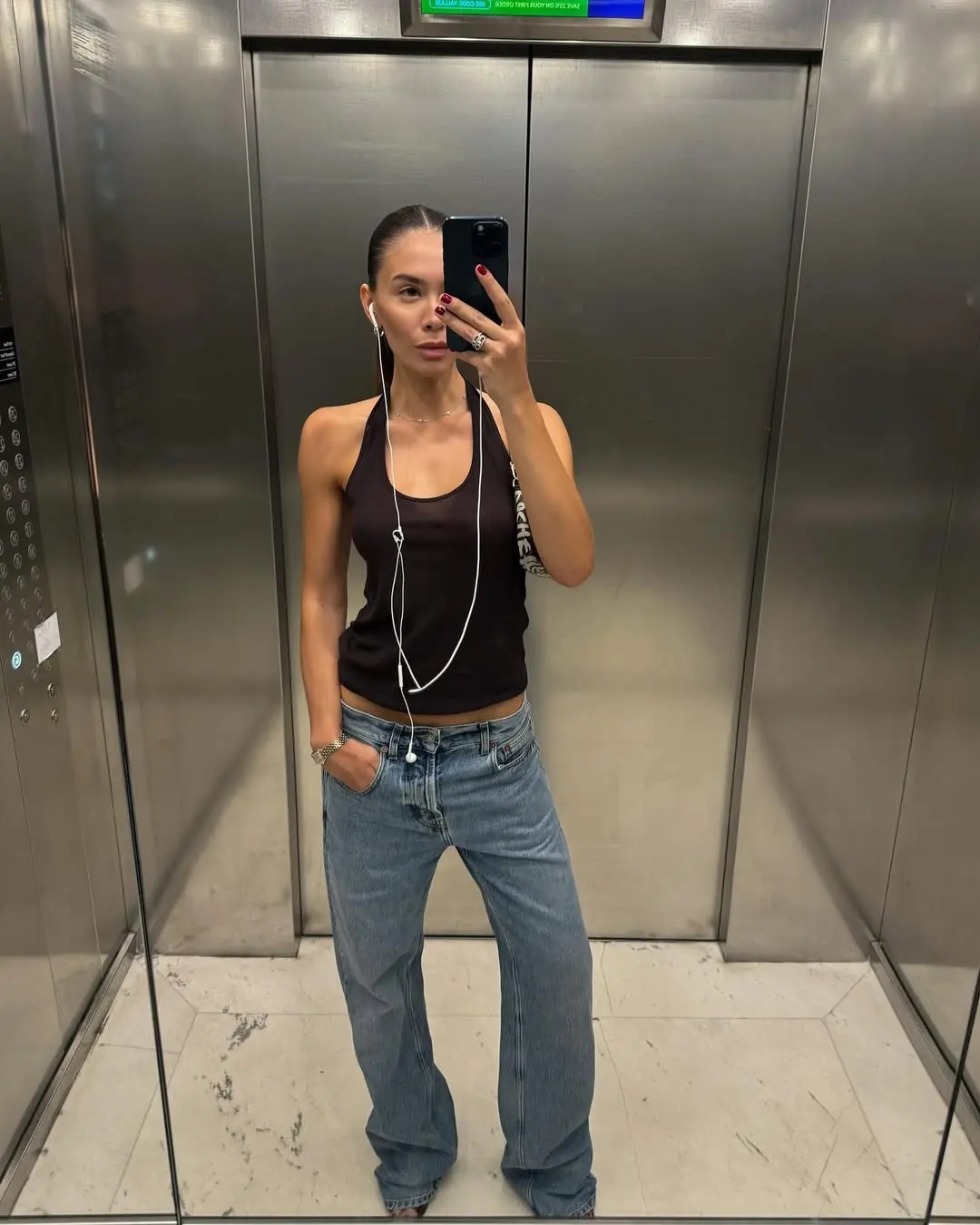 woman wearing brown tank top with jeans summer outfit 2025