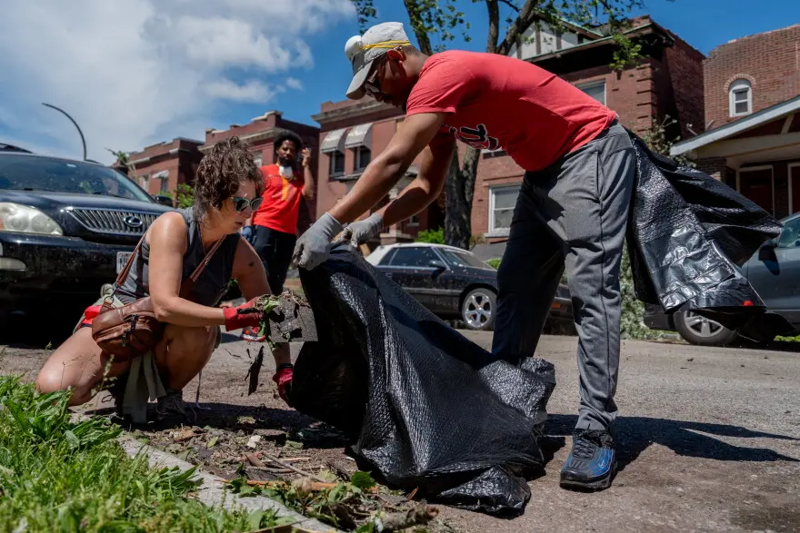 St. Louis Board of Alderman President Megan Green, left, helps pick up debris alongside Jay Nelson, Green’s chief of staff, on Saturday, May 17, 2025, in north St. Louis. An EF-3 tornado ripped through the city on Friday afternoon, killing at least 5 and damaging thousands of homes.