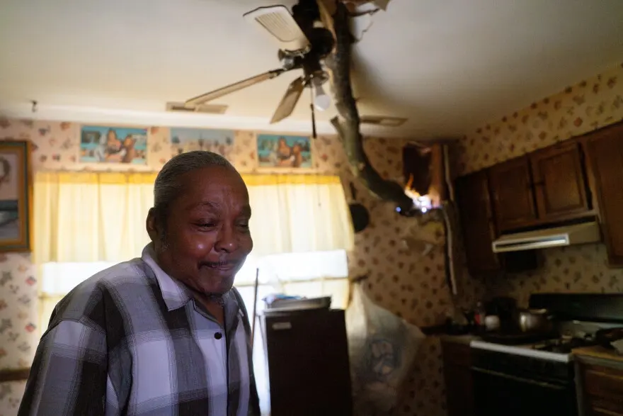 Joseph Marshall, 63, pauses while speaking about a tree limb piercing his home’s wall on Saturday, May 17, 2025, in St. Louis’ Penrose neighborhood. An EF-3 tornado ripped through the city on Friday afternoon, killing at least 5 and damaging thousands of homes.