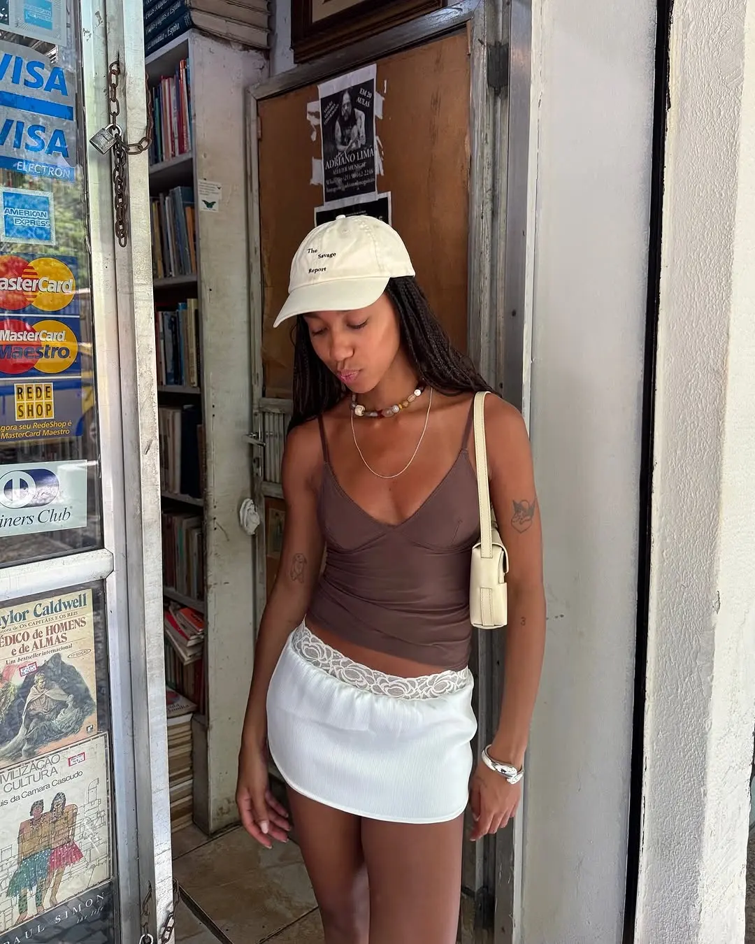 woman wearing brown tank top and white skirt summer outfit 2025