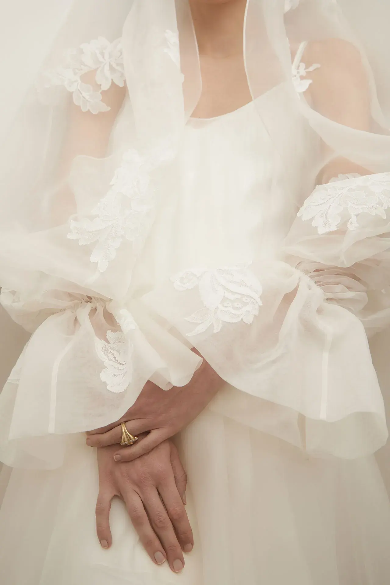 Image may contain Clothing Dress Fashion Formal Wear Gown Wedding Wedding Gown Body Part Finger Hand and Person