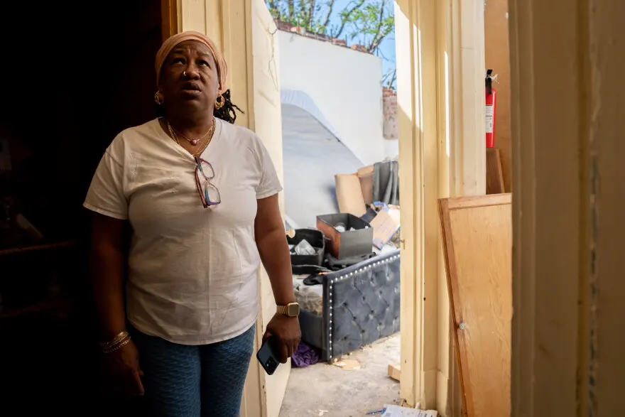 Dolly Baskin assesses damage to her former bedroom on Saturday, May 17, 2025, in north St. Louis. Storms and a tornado swept through a large part of the city’s center the prior day, damaging thousands of homes and leaving at least five people dead.
