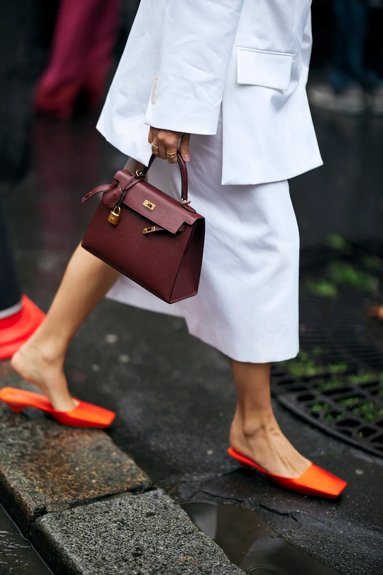 woman in Paris wearing orange satin kitten-heel mules