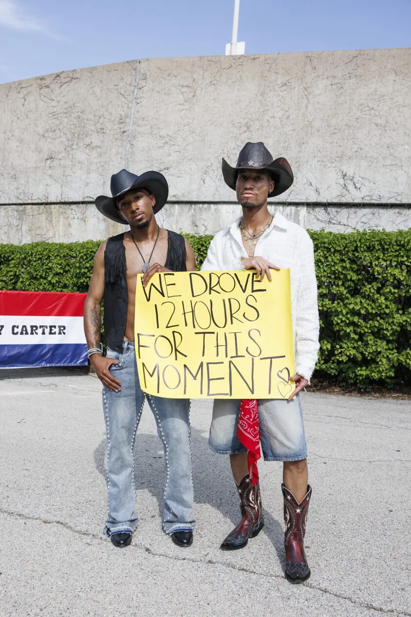 Jamel Harried (left) and Amauri Allen show off their outfits and sign before the Beyonce concert outside Soldier Field, Thursday, May 15, 2025. | Anthony Vazquez/Sun-Times