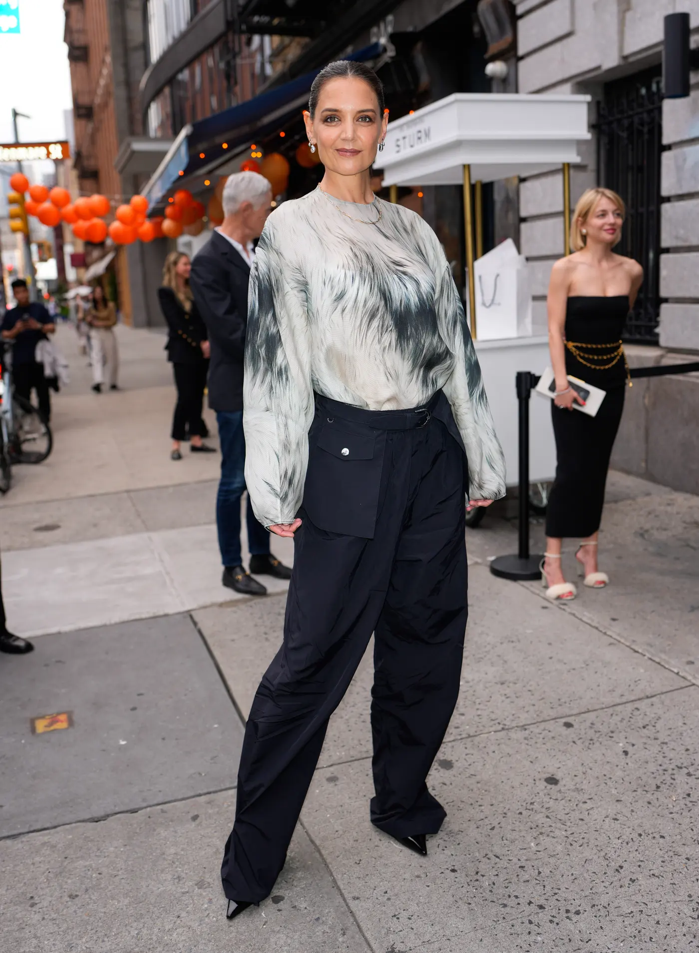 Katie Holmes wears a sheer Brandon Maxwell top and navy cargo pants