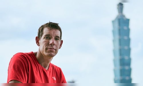 Netflix delays Alex Honnold's live ascent of Taipei 101 due to rain interference.