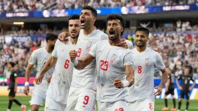 Iran's coach announces team was instructed to leave the U.S. immediately after 2-2 draw against New Zealand in World Cup debut.